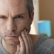Man with toothache holding cheek